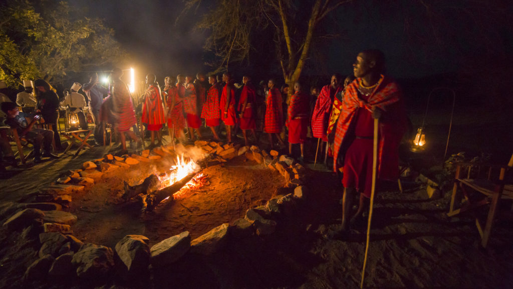 Maasai People around a fire at Mara Bushtops