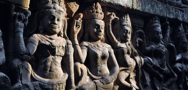 Intricate stone carvings of Khmer deities at an ancient Angkor temple in Cambodia